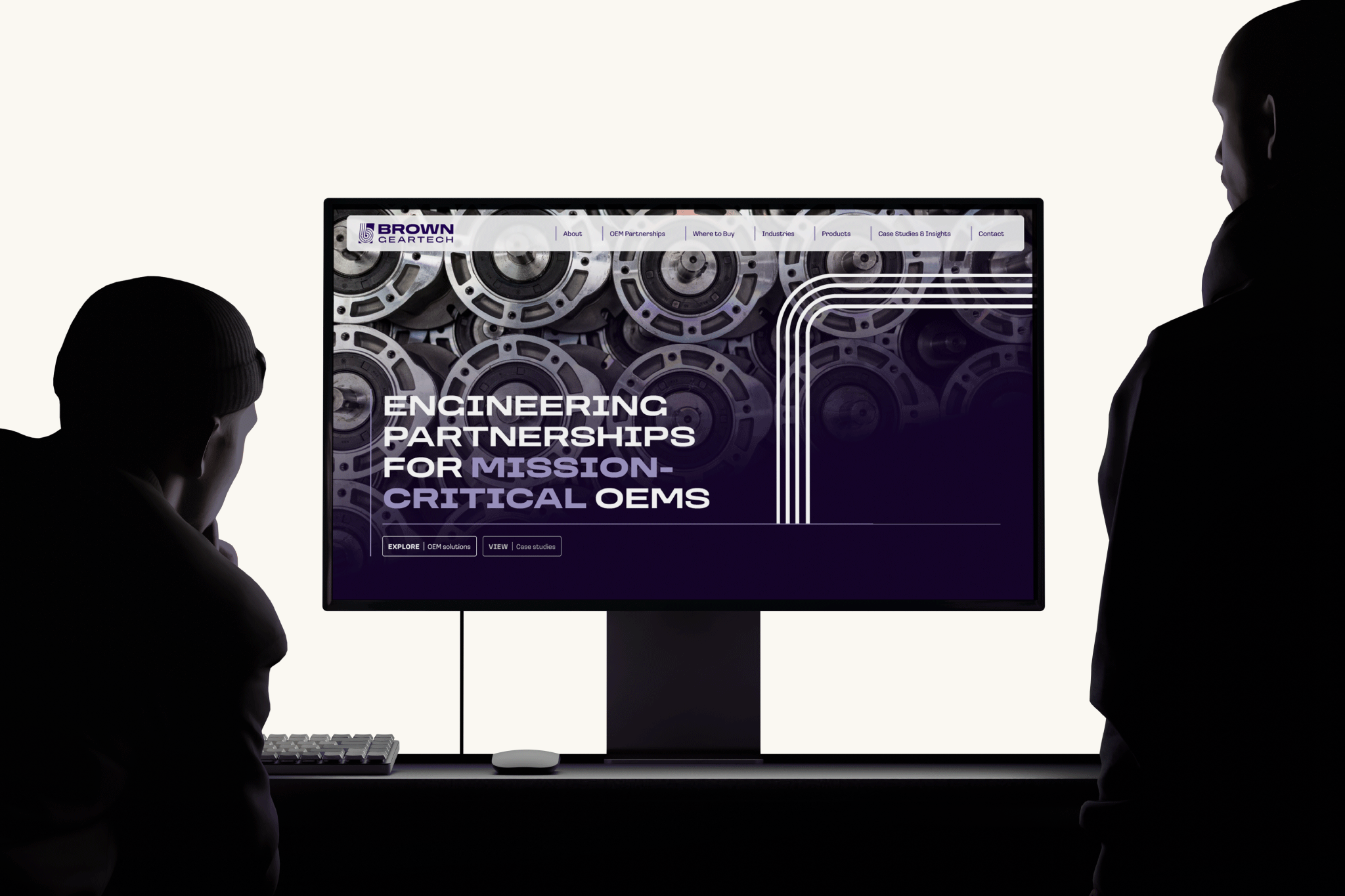 A stylised image of the Brown GearTech website displayed on a computer monitor with onlookers.